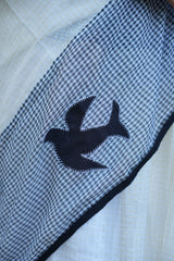 Black checkered fabric with a black fish design on a white background