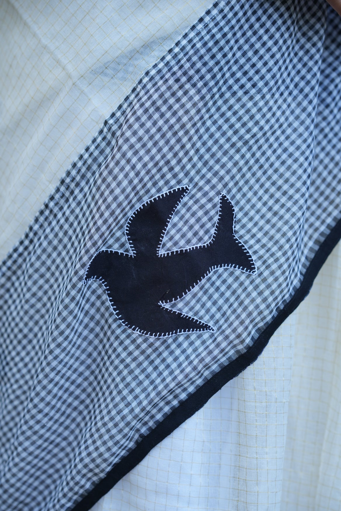 Black checkered fabric with a black fish design on a white background